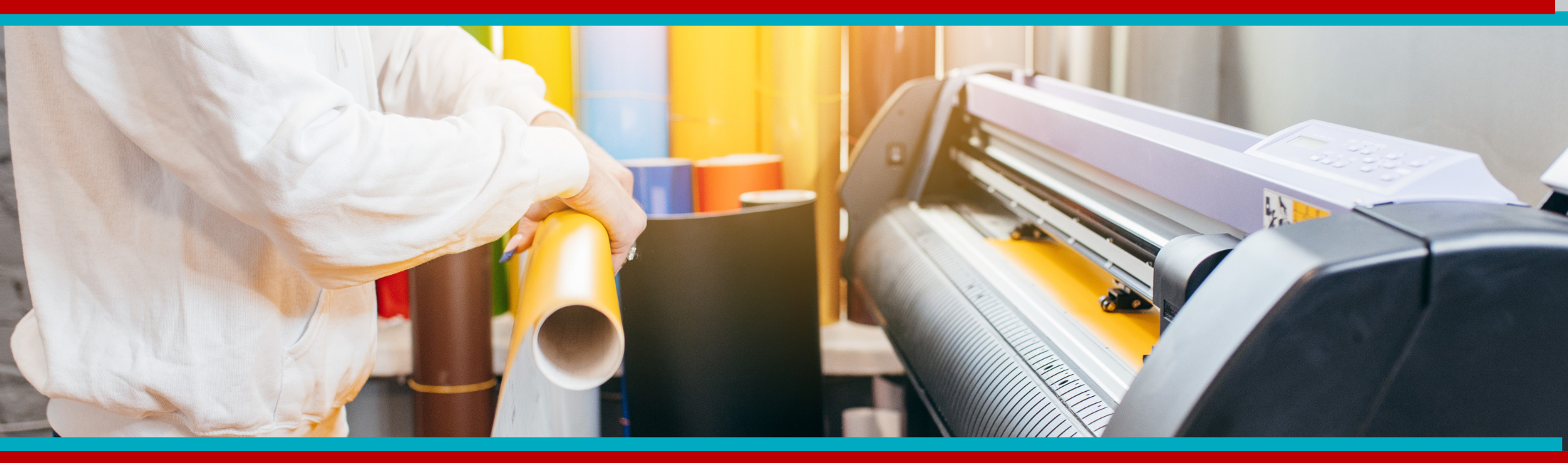 printshop worker rolling colorful paper in front of a printer