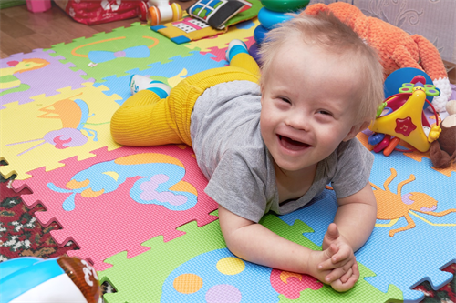 baby on floor smiling